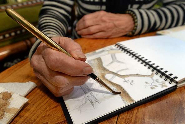 Painting with coffee over a pencil drawing. Photo Robert Tong